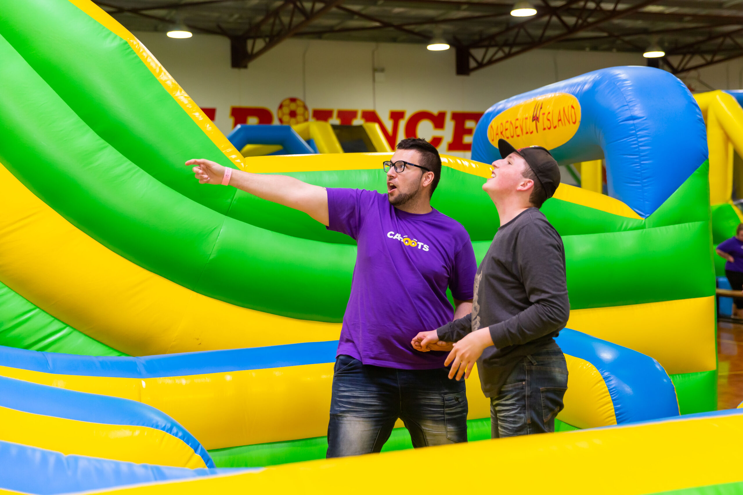 Participant and volunteer on an inflatable castle.